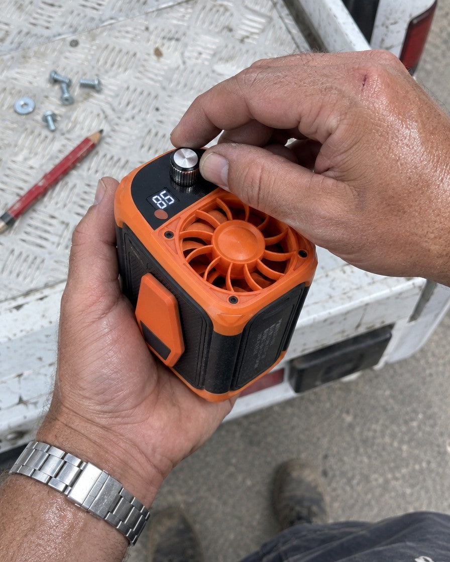 Hand turning the speed knob on the fan, display showing the speed