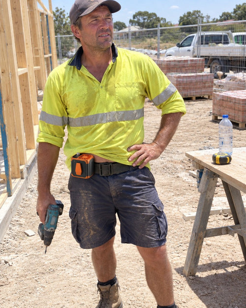 Tradie on a building site with the orange clip-on fan on his belt